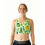 Woman wearing light green sports bra with pickle pattern design