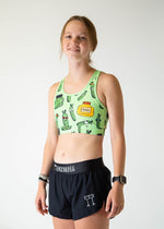 Woman wearing ChicknLegs Pickles OG sports bra in light green with pickle print