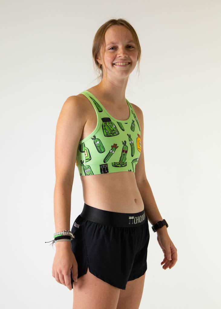 Woman wearing green sports bra with pickle pattern by ChicknLegs