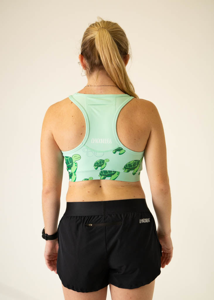 ChicknLegs OG Sports Bra in sea turtle pattern, mint green background, back view