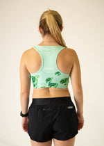 ChicknLegs mint green sports bra with sea turtle print, back view on model