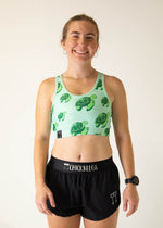 Woman wearing mint green ChicknLegs sports bra with sea turtle print pattern