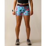 Woman wearing ChicknLegs blue compression shorts with pink flamingo and tropical leaf pattern