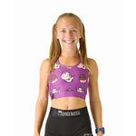 Purple sports bra with cartoon cow and chocolate milk pattern worn by smiling model