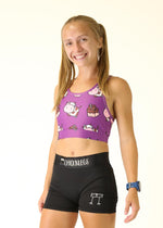 Purple sports bra with cartoon cow and chocolate milk pattern worn by blonde model
