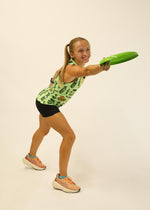 Woman wearing light green ChicknLegs performance singlet with pickle pattern while exercising