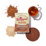 UnTapped Cocoa Waffle single packet with maple syrup, cocoa powder, and waffle cookie displayed