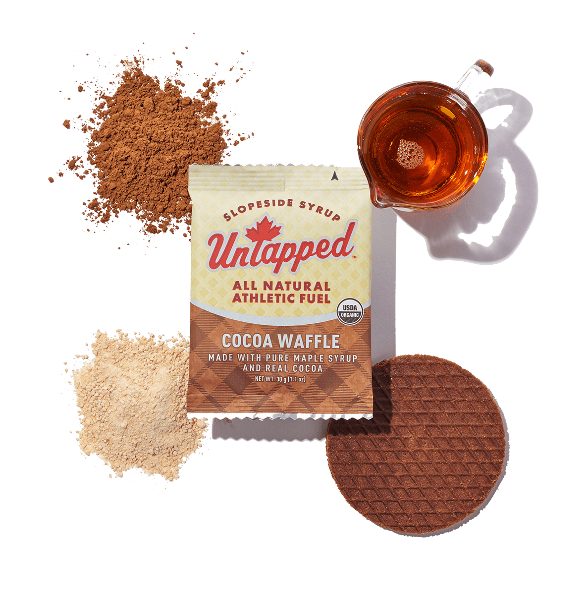 UnTapped Cocoa Waffle single packet with maple syrup, cocoa powder, and waffle cookie displayed