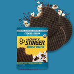 Honey Stinger Cookies and Cream Organic Energy Waffle with packaging on blue background