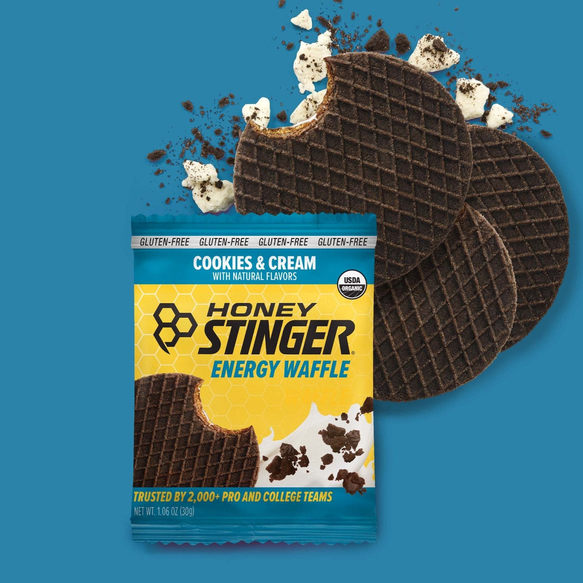 Honey Stinger Cookies and Cream Organic Energy Waffle with packaging on blue background
