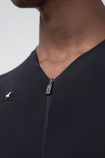 Close-up detail of Gobik branded zipper pull on black cycling jersey collar area