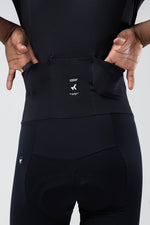 Close-up of Gobik cycling suit waist integration band showing brand label and connection system