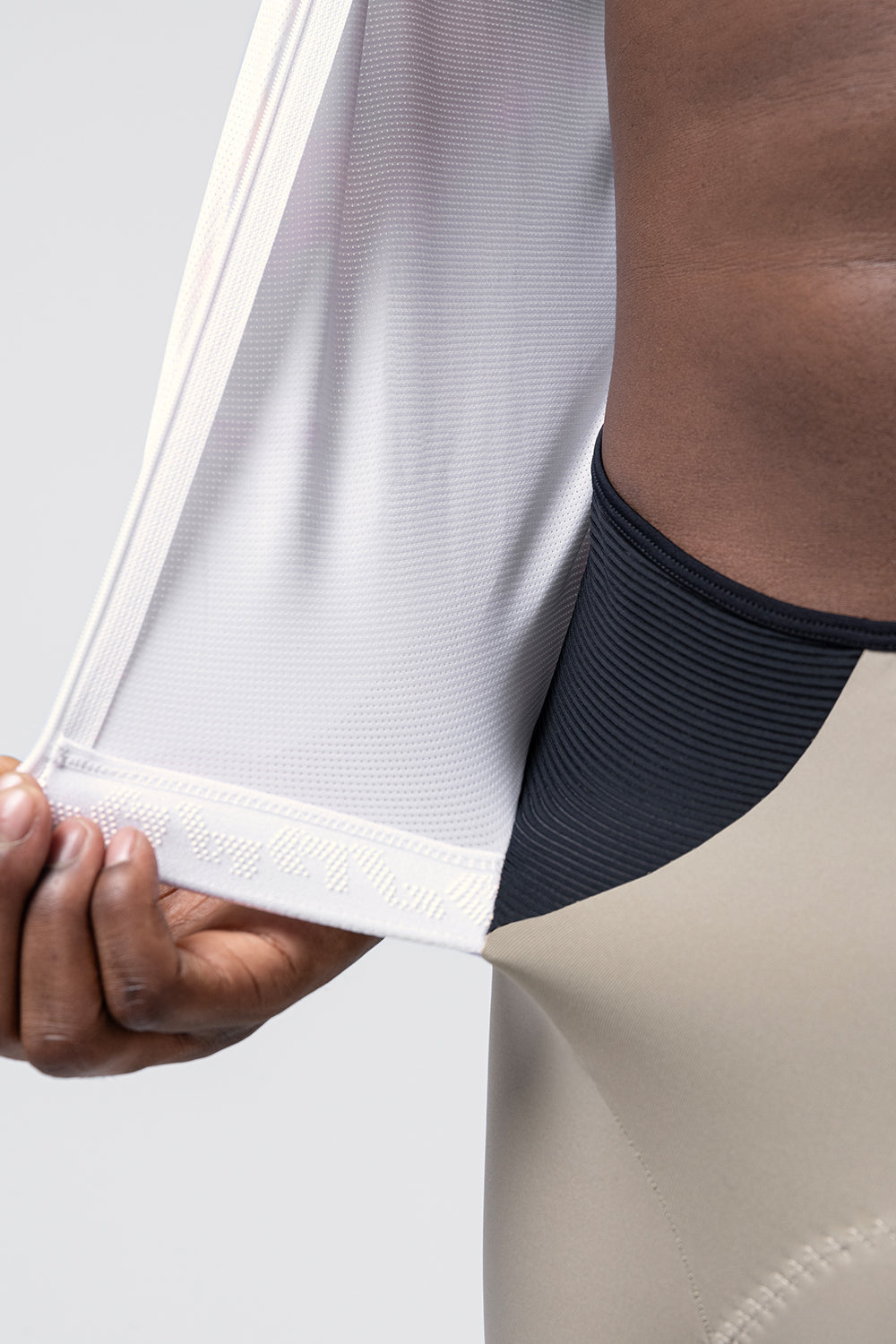 Close-up detail of Gobik Aerosuit Madison hem with silicone gripper and bib strap connection
