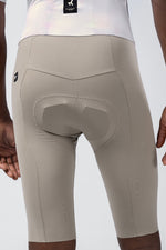 Close-up rear view of Gobik Madison bib shorts showing padded chamois in taupe color