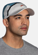 Man wearing Brooks Base Hat in Storm Blue and Light Gray colorway with red logo