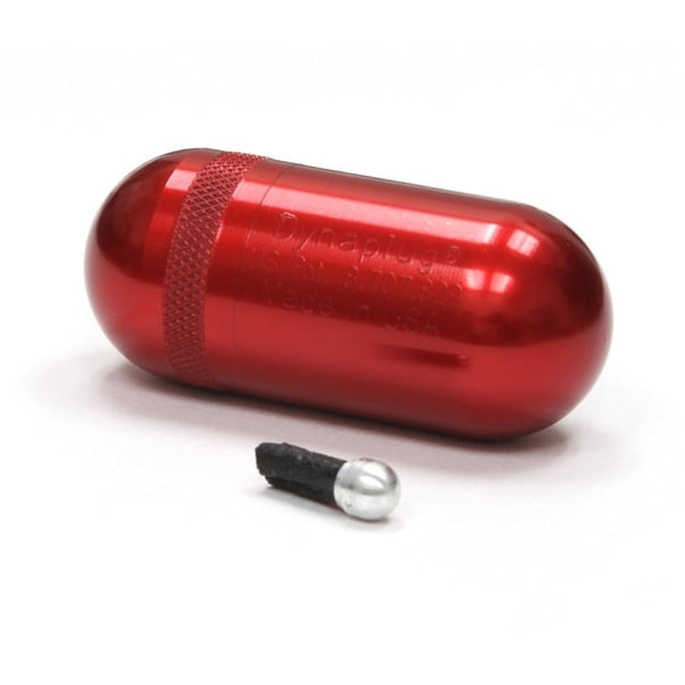 Red pill-shaped tubeless tire repair kit with small black and white repair tool