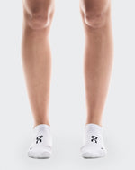 White On Core Run low-cut socks with black logo on clean background