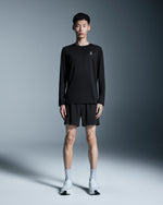 Man wearing black On 5 inch performance shorts with matching long sleeve shirt