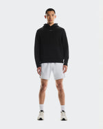 Man wearing black On Focus Tech Hoodie with gray shorts and white sneakers