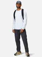 Man wearing Marmot dark gray convertible pants with white long-sleeve shirt and cap