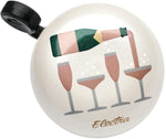 Electra bicycle bell in cream color featuring champagne bottle and wine glasses design