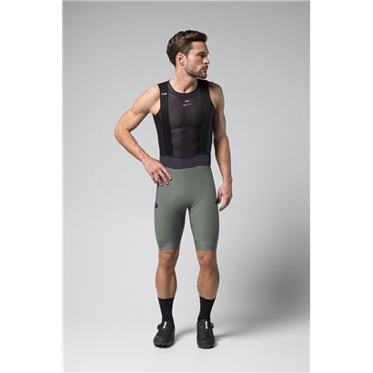 Man wearing Gobik Grit 2.0 bib shorts in evergreen color with black tank top