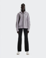 On Focus Tech Zip Hoodie in lilac worn by woman with black pants and white sneakers