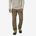 Man wearing Patagonia Venga Rock Pants in sage khaki with hiking boots