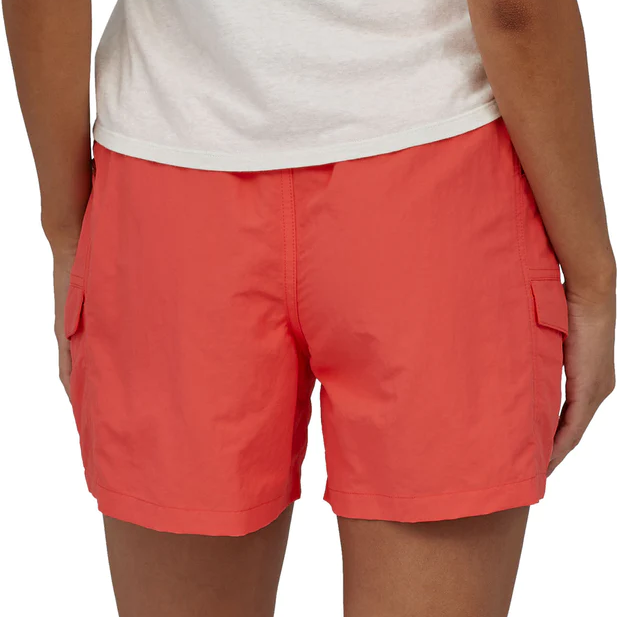 Woman wearing coral red Patagonia outdoor shorts with cargo pockets