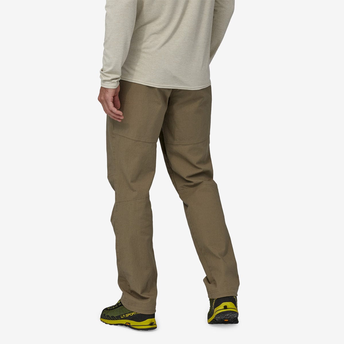 Man wearing Patagonia Venga Rock Pants in sage khaki with yellow hiking shoes