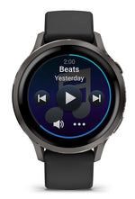 Garmin Venu 4 smartwatch in slate gray with black band showing music interface