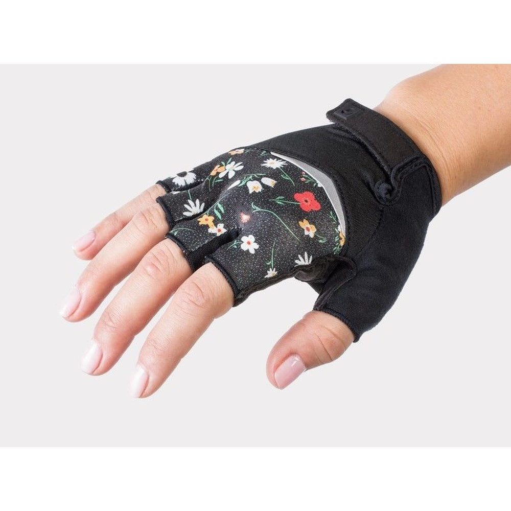 Black cycling glove with colorful floral pattern on palm worn on hand