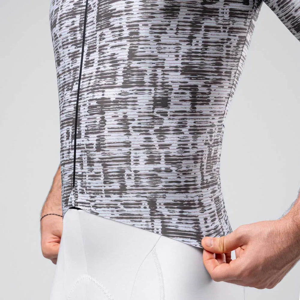 Grey patterned cycling jersey with abstract dot design on model