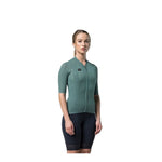 Woman wearing Gobik Phantom Jersey in sage green with black cycling shorts