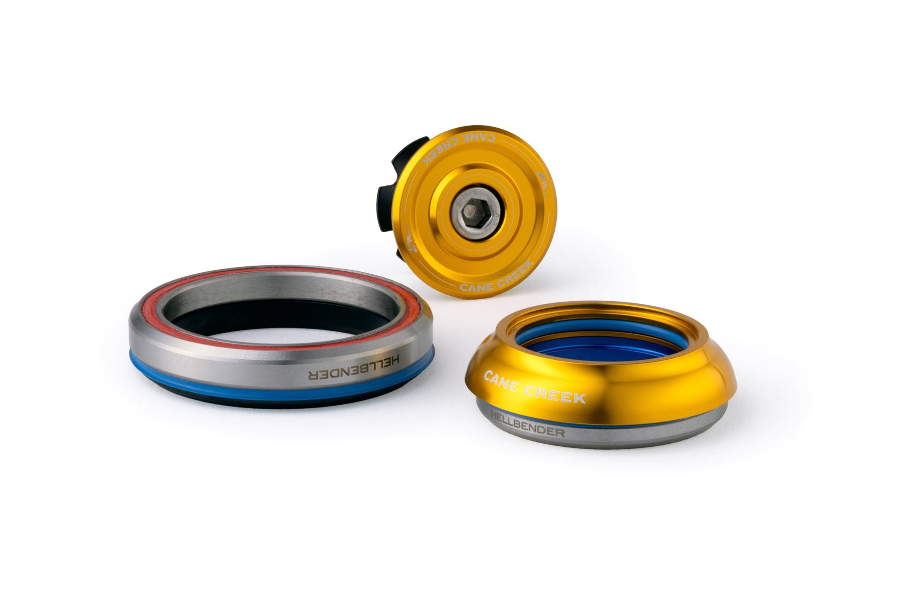 Cane Creek Hellbender headset components in gold and silver finish on white background