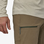 Close-up of Patagonia Men's Venga Rock Pants in sage khaki showing zippered pocket detail