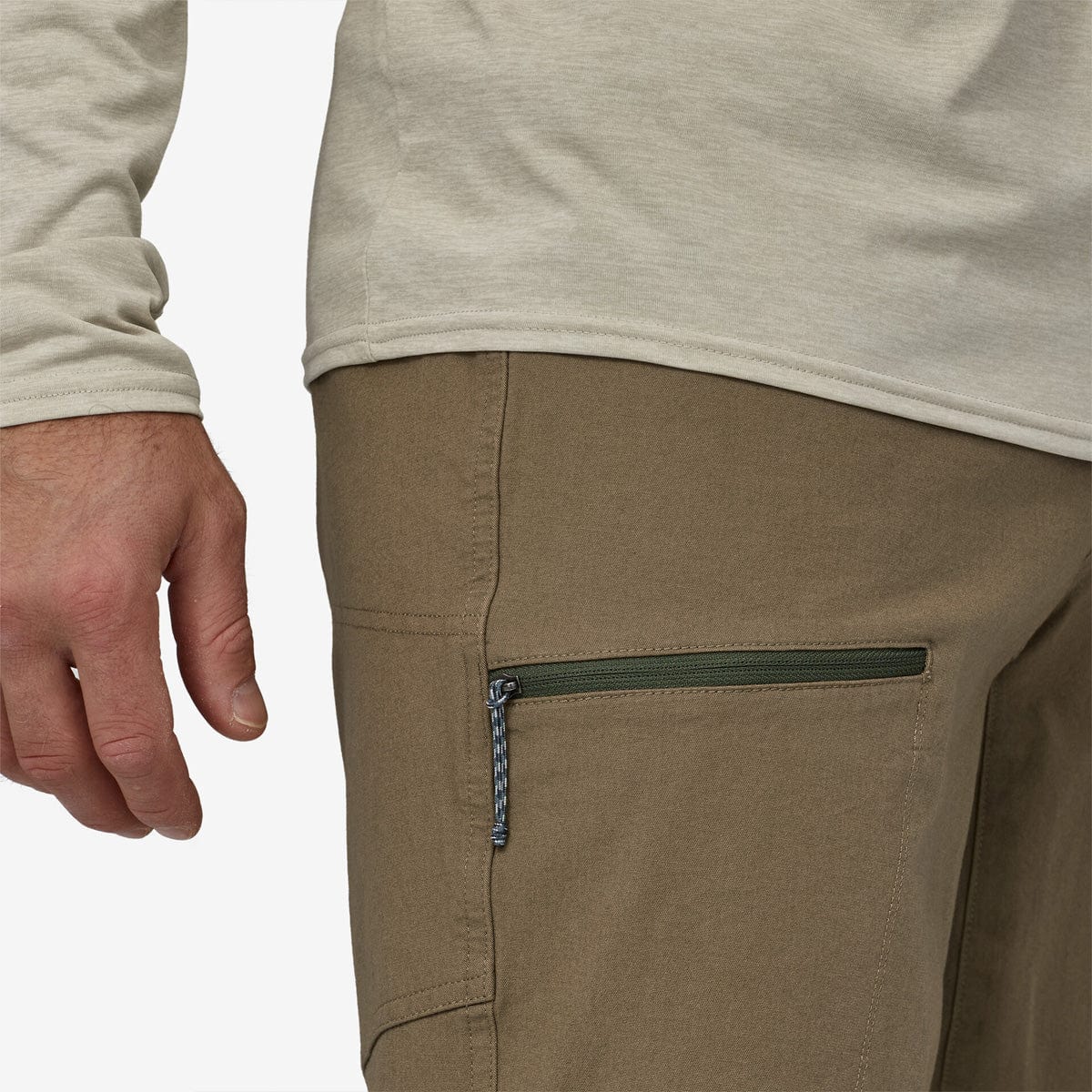 Close-up of Patagonia Men's Venga Rock Pants in sage khaki showing zippered pocket detail