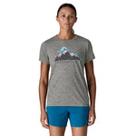 Female model wearing Patagonia Capilene Cool Daily Shirt in feather grey, front view