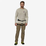 Man wearing Patagonia Venga Rock Pants in Sage Khaki with climbing harness