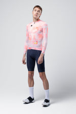 Male cyclist wearing Gobik Vanquish long sleeve jersey in flamingo pink pixelated pattern