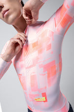 Model wearing Gobik Vanquish long sleeve cycling jersey in flamingo pink with abstract pattern