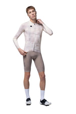 Model wearing Gobik Vanquish long sleeve cycling jersey in whisper color with matching shorts