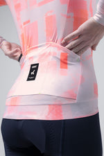 Gobik Vanquish long sleeve cycling jersey in flamingo pink tie-dye pattern on model