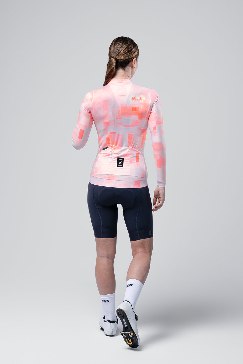 Gobik Vanquish long sleeve cycling jersey in flamingo pink pixelated pattern, rear view