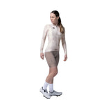 Woman wearing Gobik Vanquish long sleeve cycling jersey in whisper color with cycling shorts