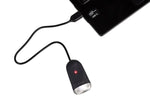 Black Eltin bike light connected to charging device with red LED indicator