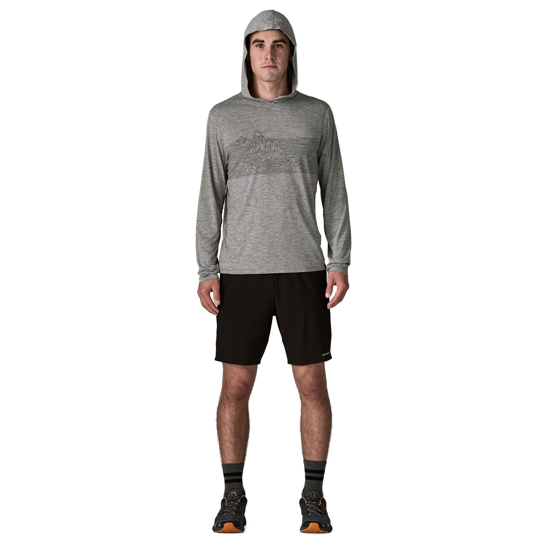 Man wearing grey Patagonia hooded long sleeve shirt with black shorts