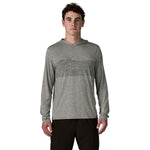 Man wearing grey Patagonia hooded long sleeve shirt with geometric mountain design