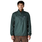 Man wearing Patagonia Houdini Stash half-zip pullover jacket in dark green