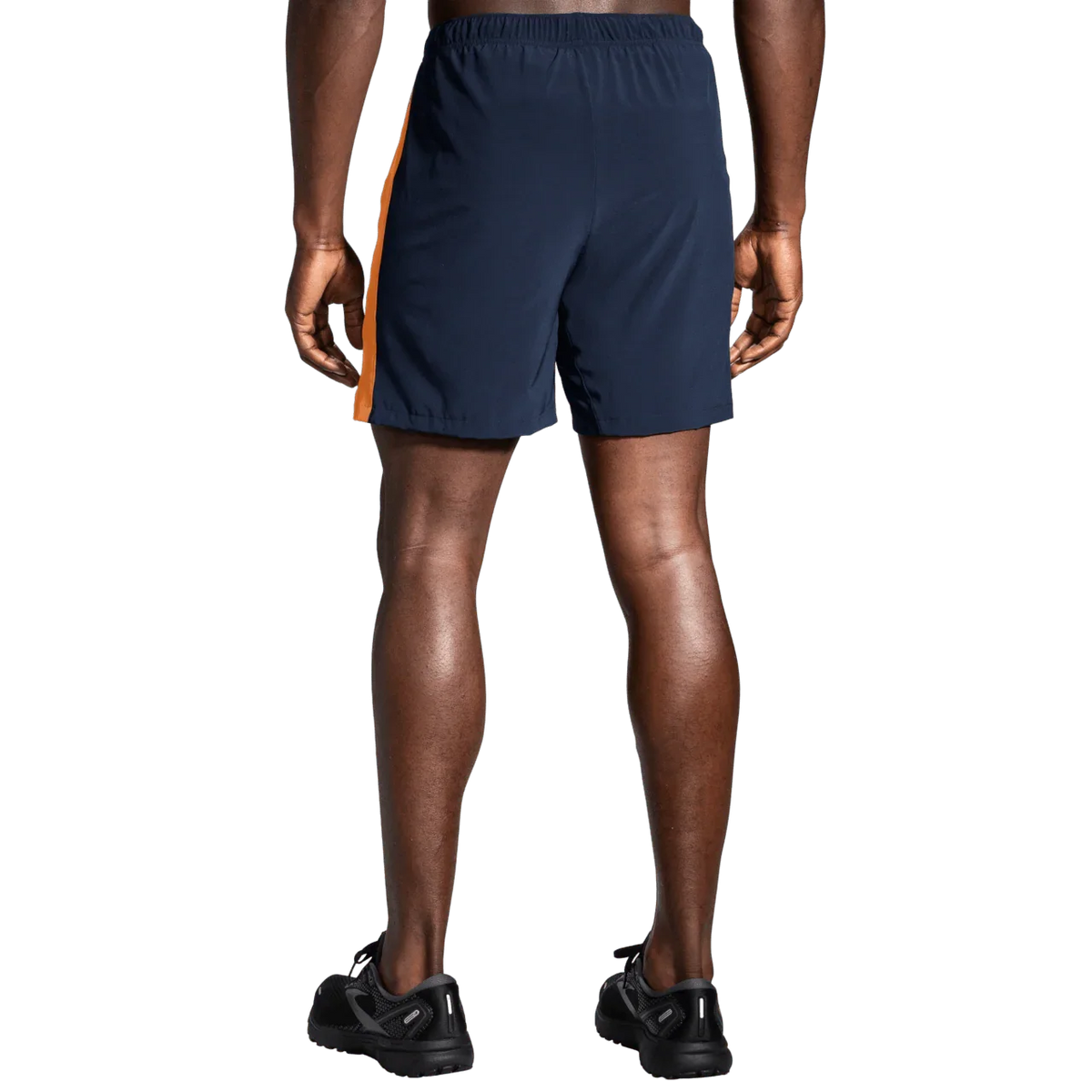 Brooks Moment 7-inch men's running shorts in navy with orange side stripe, rear view